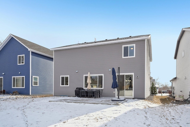 view of snow covered rear of property