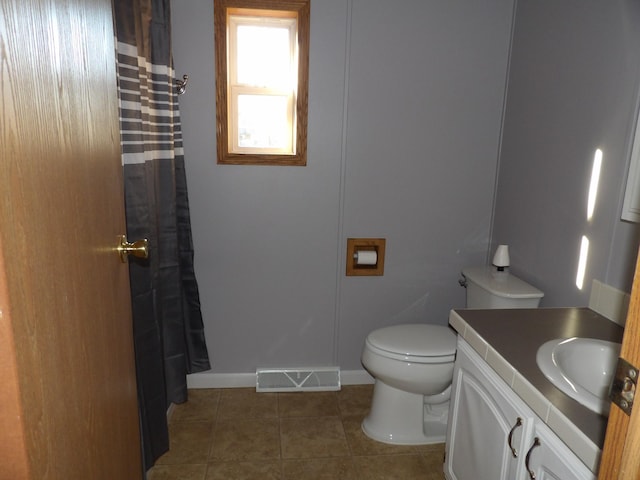 bathroom with tile patterned floors, vanity, and toilet