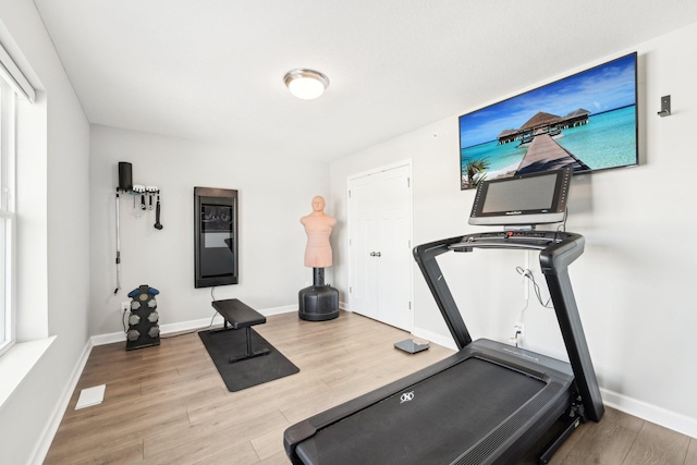 workout area with hardwood / wood-style flooring