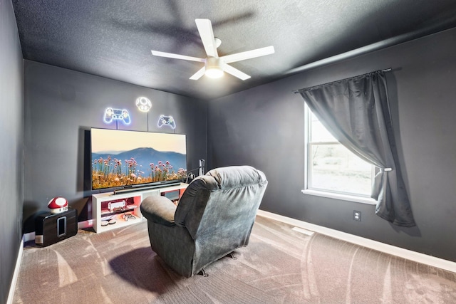 home theater featuring ceiling fan, light carpet, and a textured ceiling