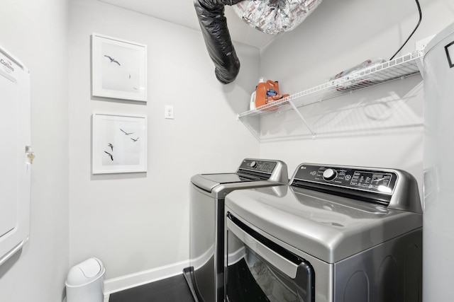 laundry room with washing machine and clothes dryer