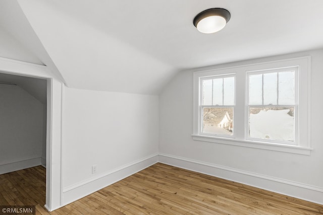 bonus room with light hardwood / wood-style flooring and vaulted ceiling