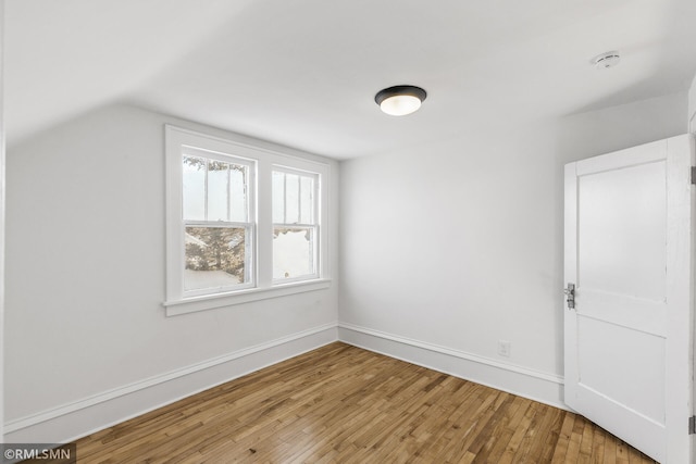 additional living space featuring light hardwood / wood-style floors and lofted ceiling