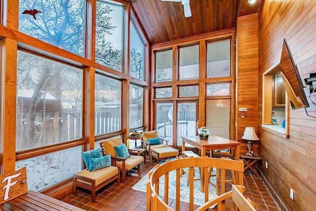 sunroom featuring wood ceiling, plenty of natural light, ceiling fan, and vaulted ceiling