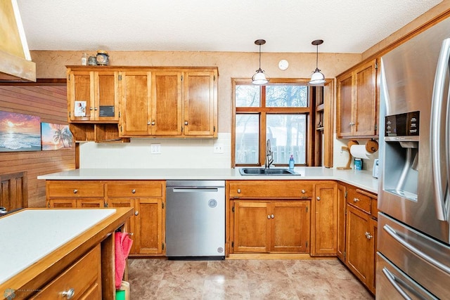 kitchen with hanging light fixtures, sink, and appliances with stainless steel finishes