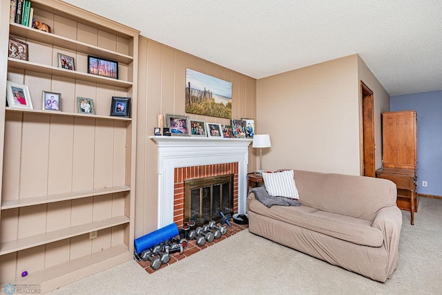 living room with carpet, built in features, a textured ceiling, and a brick fireplace