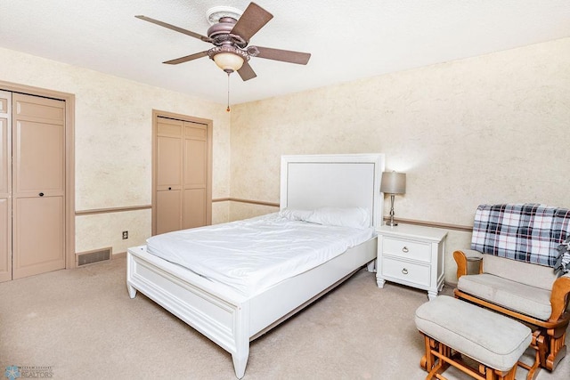 bedroom featuring ceiling fan and light carpet