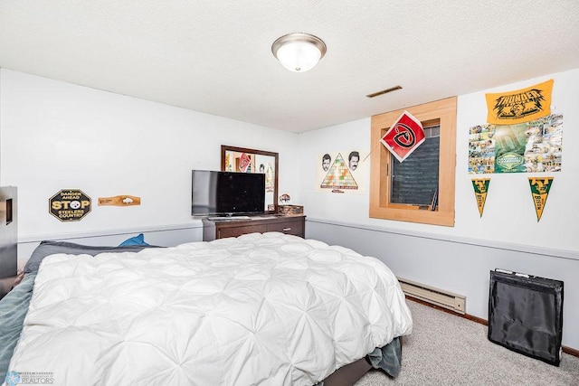 carpeted bedroom with a baseboard heating unit and a textured ceiling