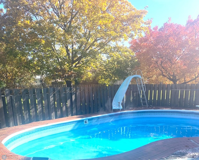 view of pool with a water slide