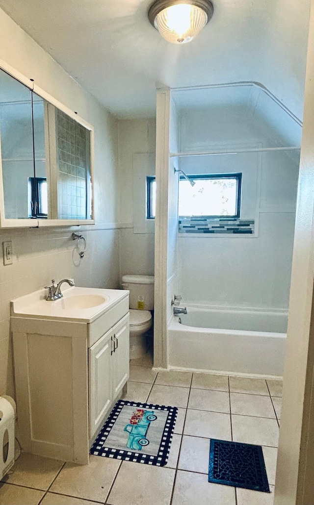 full bathroom featuring washtub / shower combination, toilet, tile patterned floors, and vanity