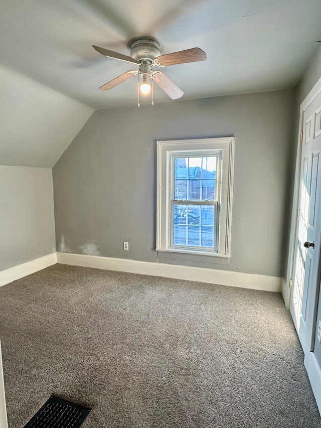 bonus room with ceiling fan, carpet flooring, and vaulted ceiling