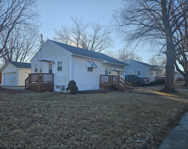 exterior space featuring a garage and a front lawn