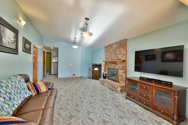 living room with carpet floors, vaulted ceiling, and a brick fireplace