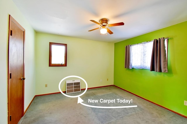 carpeted empty room featuring ceiling fan