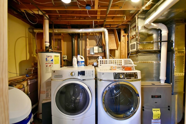 washroom featuring water heater and washing machine and clothes dryer