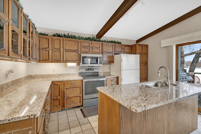 kitchen featuring appliances with stainless steel finishes, sink, a center island with sink, and vaulted ceiling with beams