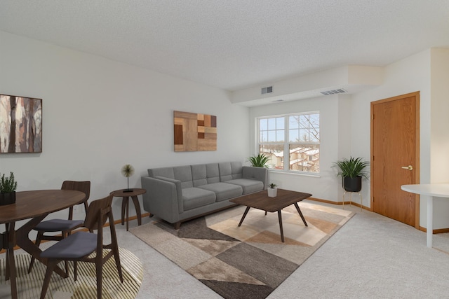 carpeted living room with a textured ceiling