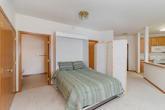 bedroom featuring light carpet and a textured ceiling