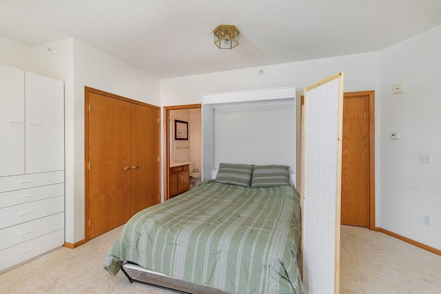 bedroom featuring light colored carpet and a textured ceiling