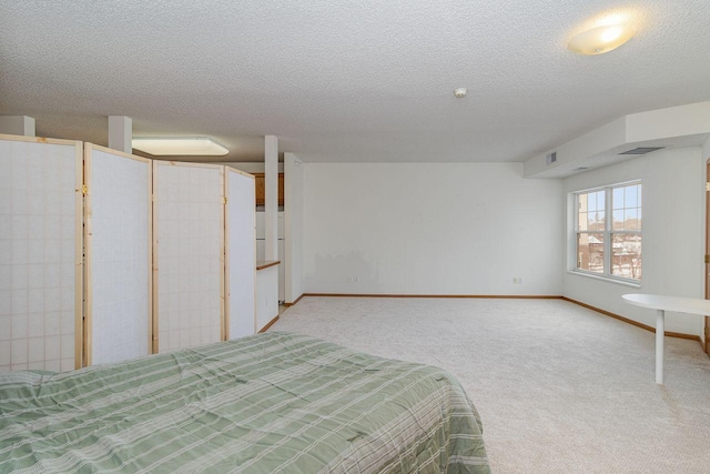 unfurnished bedroom featuring carpet and a textured ceiling