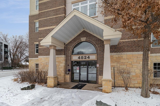 view of snow covered property entrance