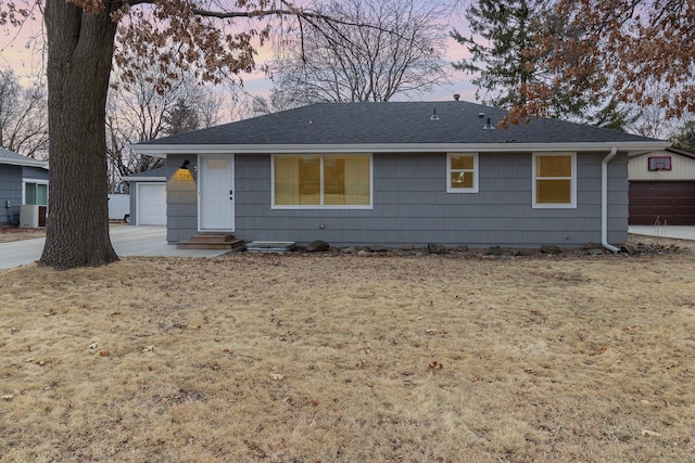 ranch-style house featuring entry steps, roof with shingles, and central air condition unit