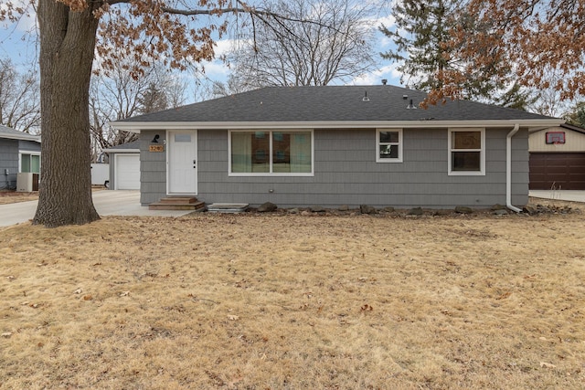 ranch-style house featuring a garage, a shingled roof, and entry steps