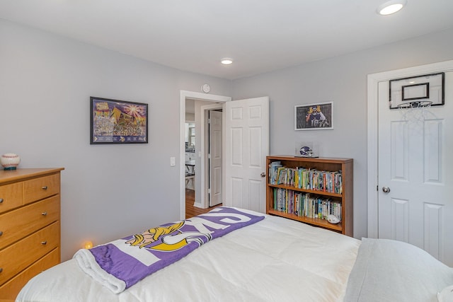 bedroom with recessed lighting and wood finished floors