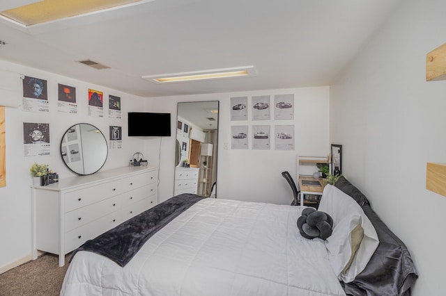 carpeted bedroom featuring visible vents