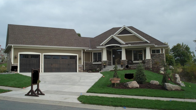 craftsman-style home with a garage and a front yard