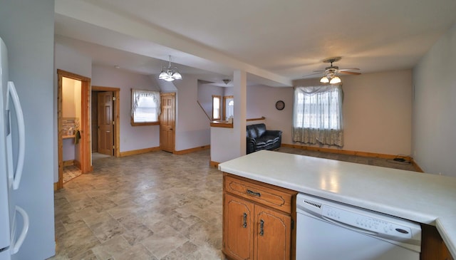 kitchen with a healthy amount of sunlight, white appliances, brown cabinets, and a ceiling fan