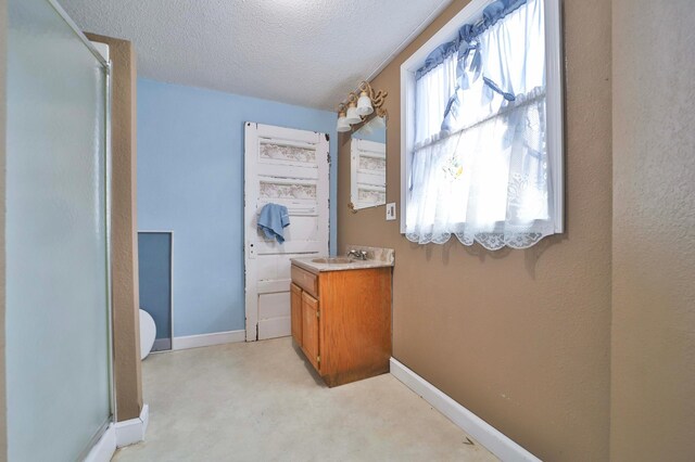 full bathroom with baseboards, a textured ceiling, and a stall shower
