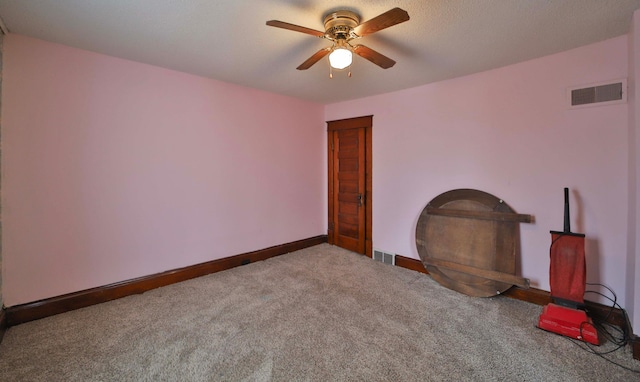 interior space with baseboards, ceiling fan, and visible vents