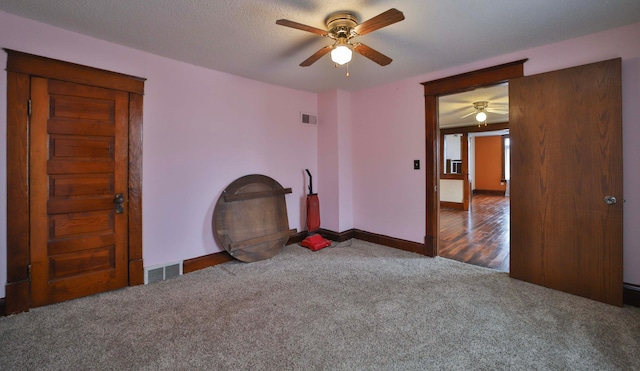 unfurnished bedroom featuring visible vents, ceiling fan, carpet flooring, and a textured ceiling