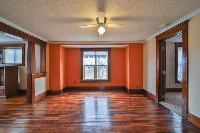empty room with baseboards, ceiling fan, ornamental molding, and wood-type flooring