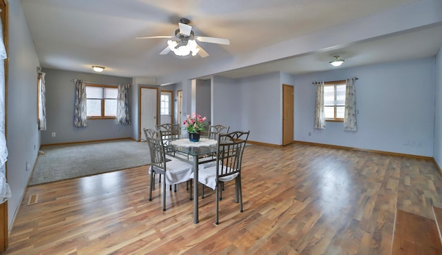 dining area with light wood-style flooring, baseboards, and ceiling fan