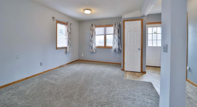 unfurnished bedroom with baseboards and carpet