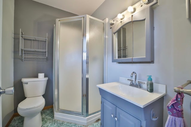 full bathroom featuring toilet, vanity, a stall shower, and baseboards