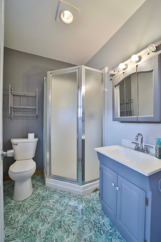 bathroom featuring vaulted ceiling, toilet, vanity, a shower stall, and baseboards
