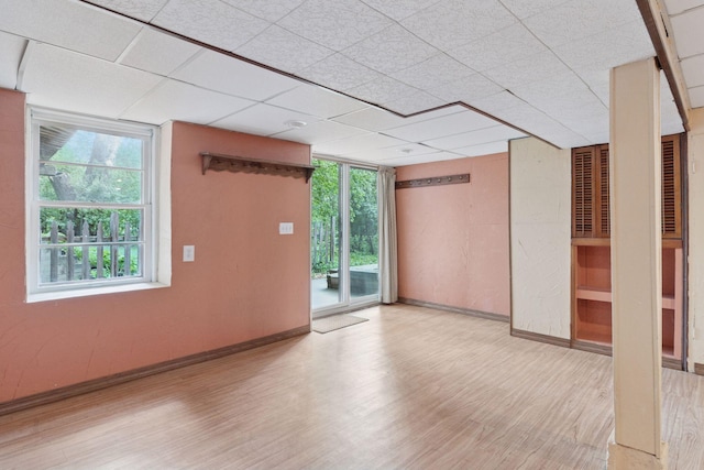 empty room featuring wood finished floors and baseboards