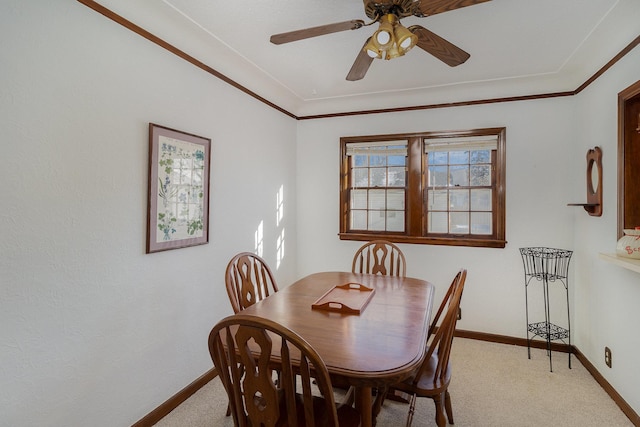 carpeted dining area featuring ceiling fan and ornamental molding