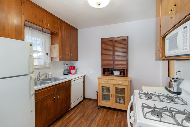 kitchen with dark wood-type flooring, sink, and white appliances