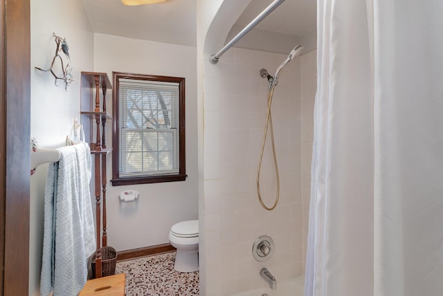 bathroom with toilet and shower / bath combo