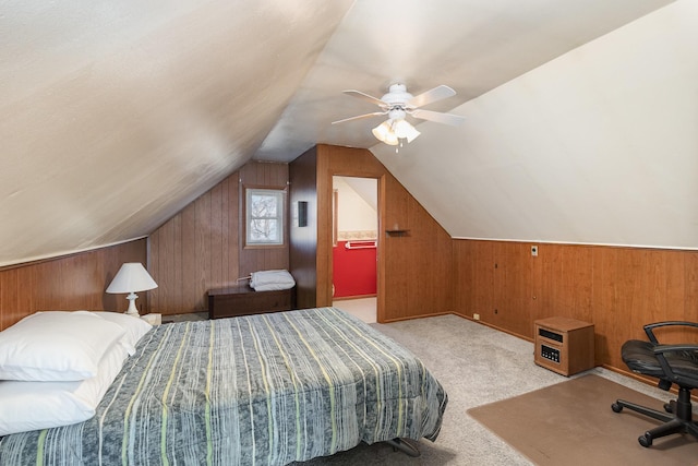 bedroom featuring ceiling fan, light colored carpet, lofted ceiling, and wooden walls