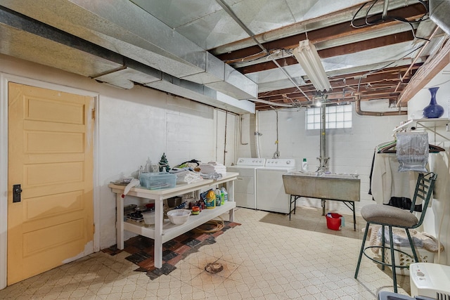 basement featuring sink and independent washer and dryer