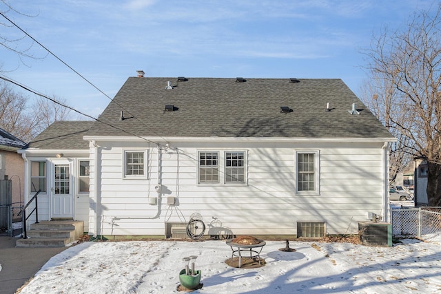 snow covered house with a fire pit