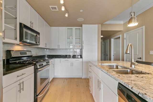 kitchen with appliances with stainless steel finishes and white cabinets