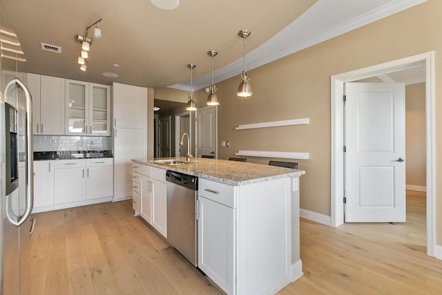 kitchen featuring sink, backsplash, stainless steel appliances, light stone countertops, and white cabinets