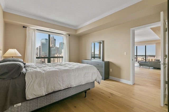 bedroom with crown molding and light hardwood / wood-style floors