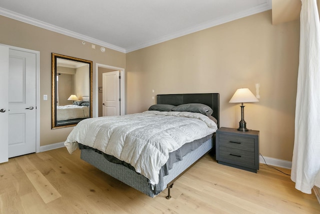 bedroom with crown molding and light hardwood / wood-style floors